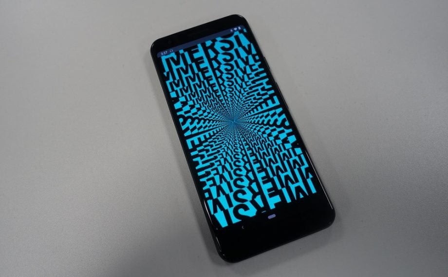 A black smartphone kept on a table displaying a picture from Dirac mobile app