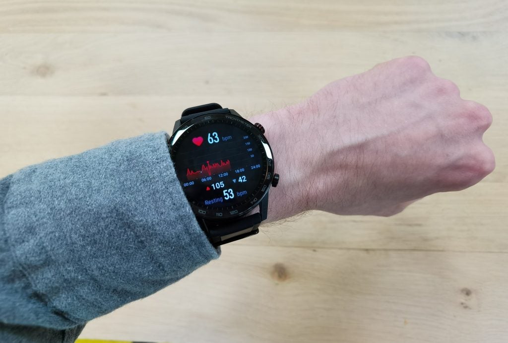 A black Honor MagicWatch 2 wore on hand displaying heart rate