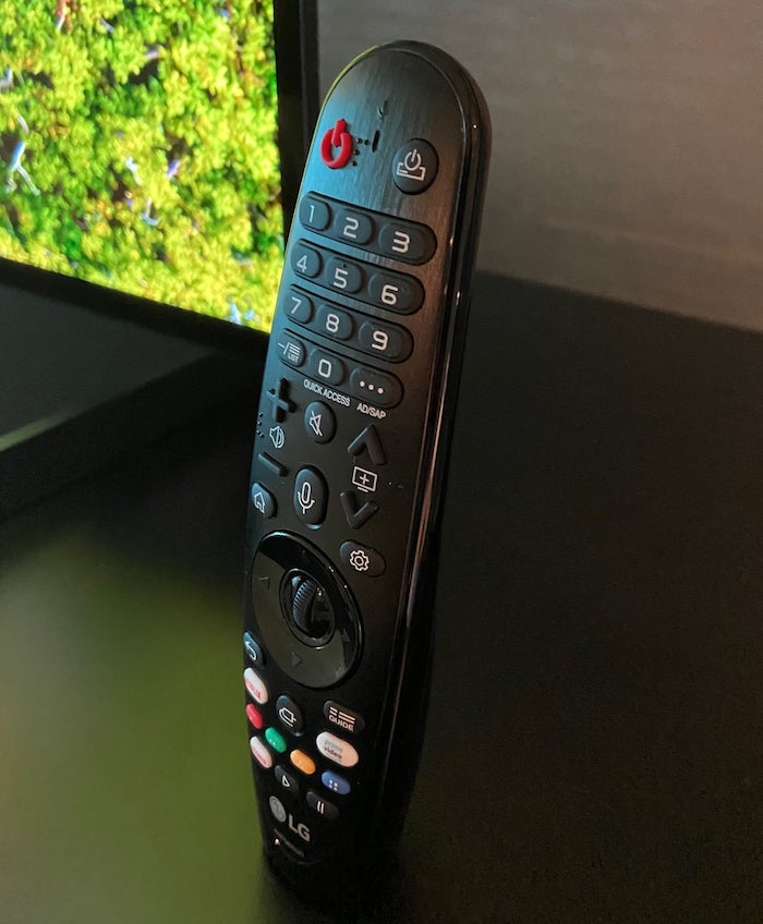 OLED77ZXPicture of a LG OLED 77ZX TV's black remote standing on a table