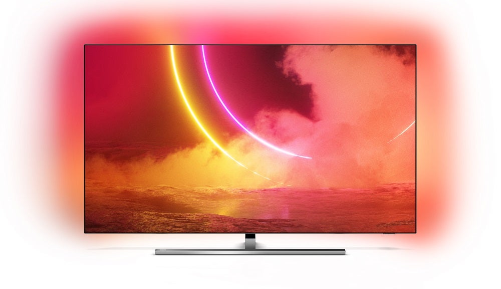A silver-black Philips OLED855 TV standing on white background displaying red-orange wallpaper