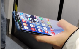A blue Huawei P40 Pro held in hand displaying homescreen