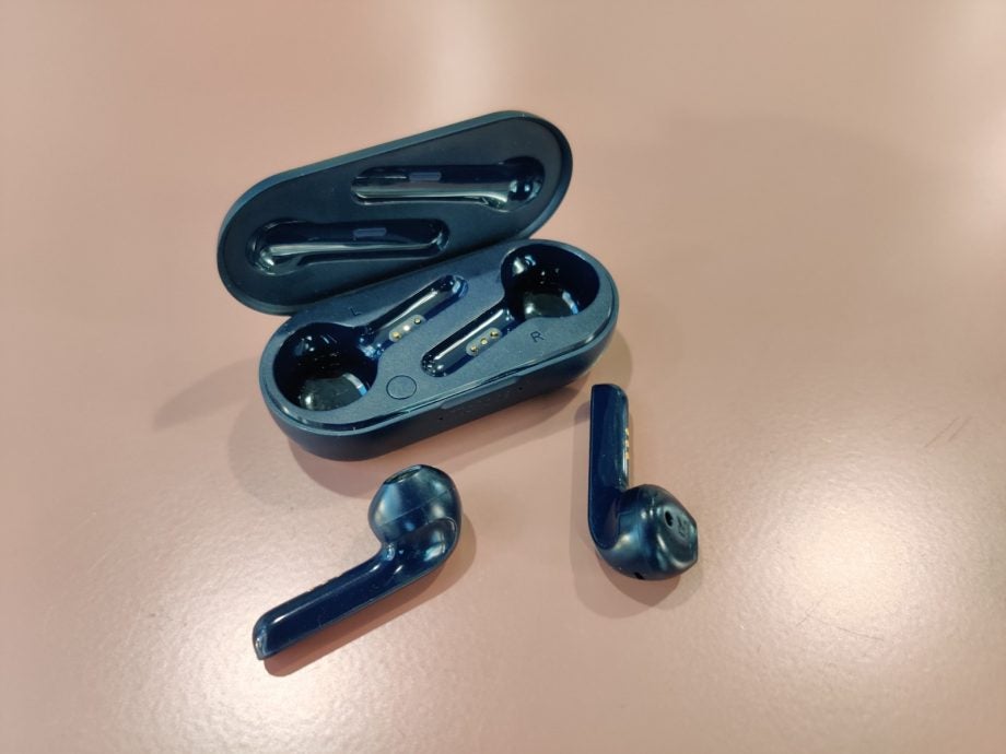 Picture of a TicPods 2 Pro earbuds with it’s case behind kept on a table