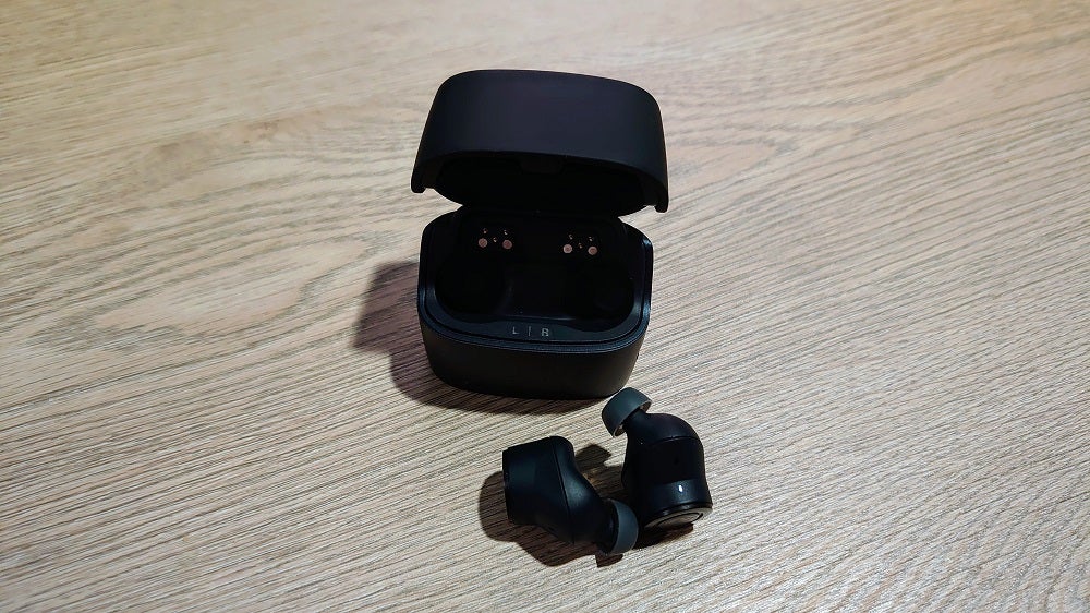 Audio Technica ATH-ANC300TWPicture of black earbuds with it's case standing behind kept on a table