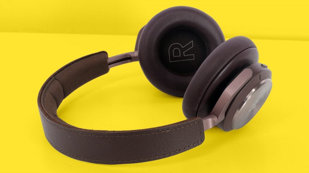 Beoplay H9 3rd GenSide view of black B&O headphones kept on a yellow background