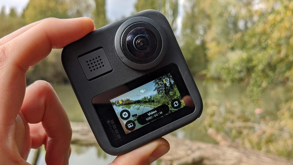 A gray GoPro Max camera held in hand