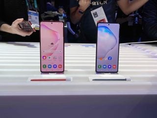 Two Samsung Galaxy Note 10 Lite standing on a table on stands displaying homescreen