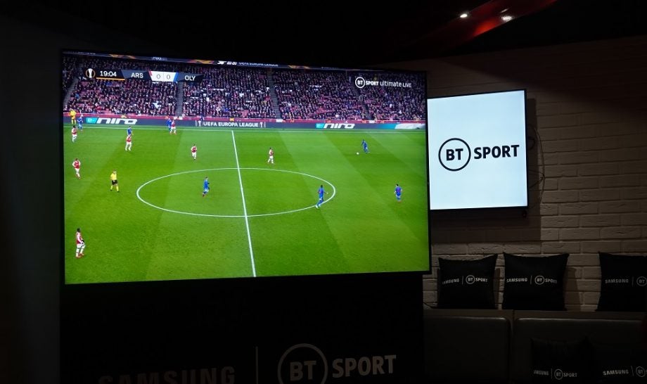 A black Samsung 8K TV displaying a soccer match on BT Sport