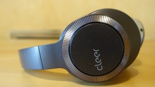 Side view of blue-silver and black Cleer Flow II headphones kept on a table