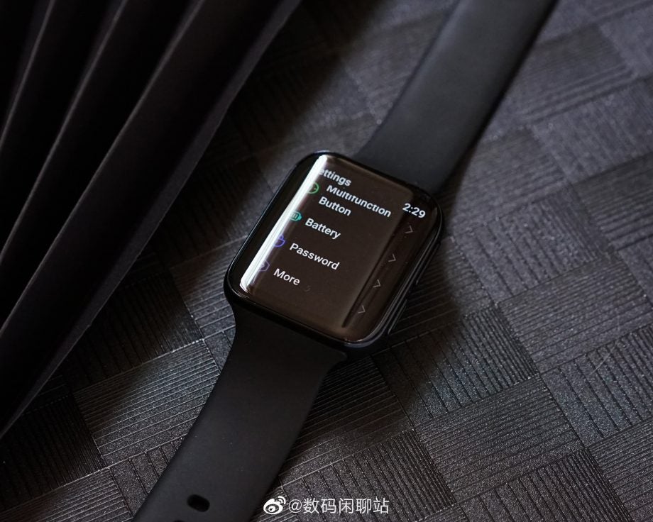 A black Oppo Watch kept on a black background displaying settings menu screen