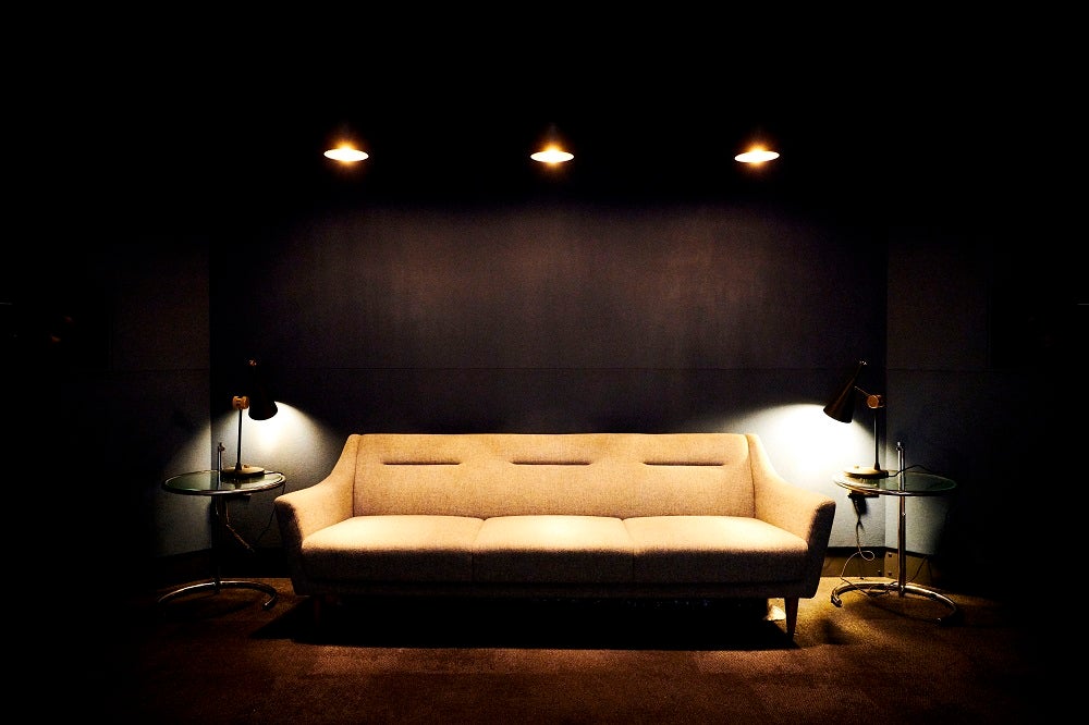 A picture of a couch with all lights pointed towards couch, couch in Sky studios