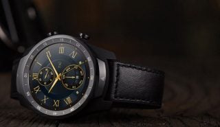 Picture of a gray-black Ticwatch Pro 2020 kept on a wooden floor