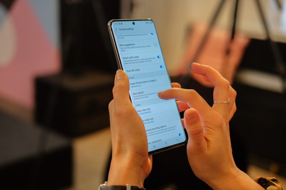 A Samsung Galaxy S20 Ultra held in hand displaying camera settings menu screen