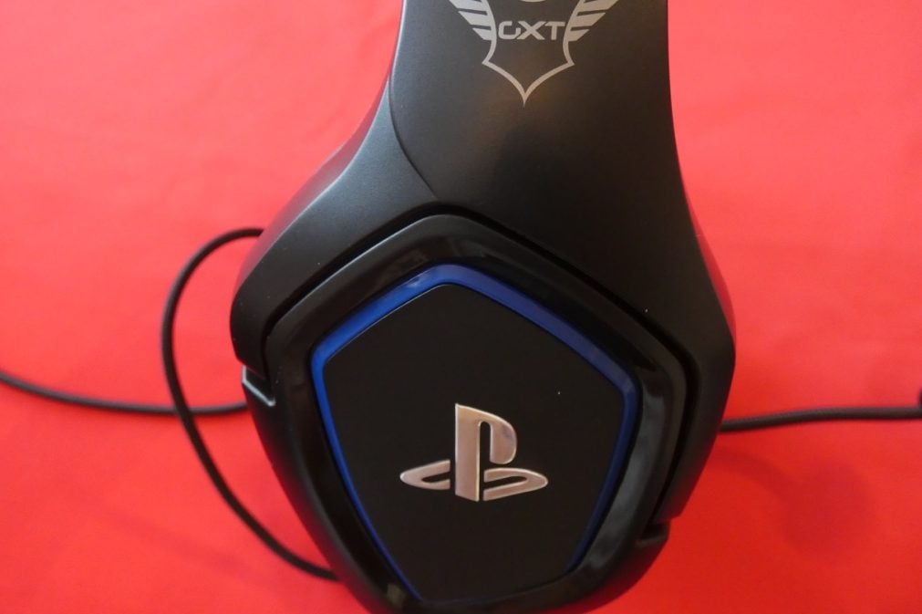 GXT 488 Forze PS4 HeadsetSide view of GXT 488 Forze PS4 gaming headset kept on a red background with GXT and PS logo on side