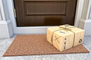 A packed box kept outside a house showing contactless delivery