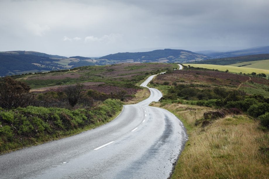 A beautiful picture of an empty road winding across Moorland