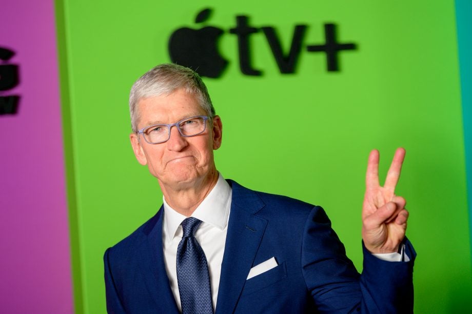 A picture of Tim Cook posing with a victory sign