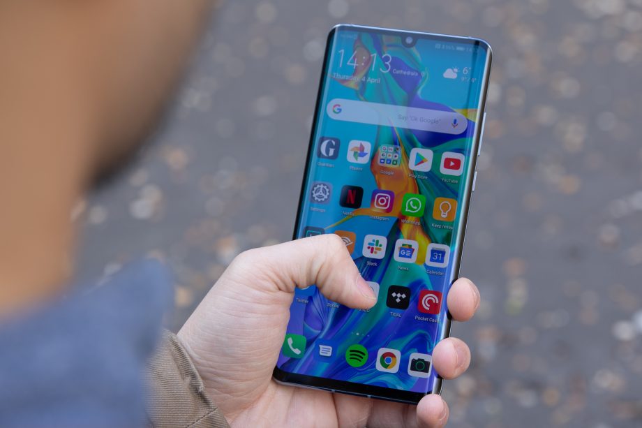 A Huawei P30 Pro held in hand displaying homescreen