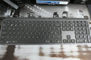 View from top of a black Logitech MX keyboard kept on a table