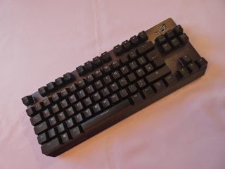 View from top of a black ROG Strix Scope TKL Deluxe keyboard kept on a white background