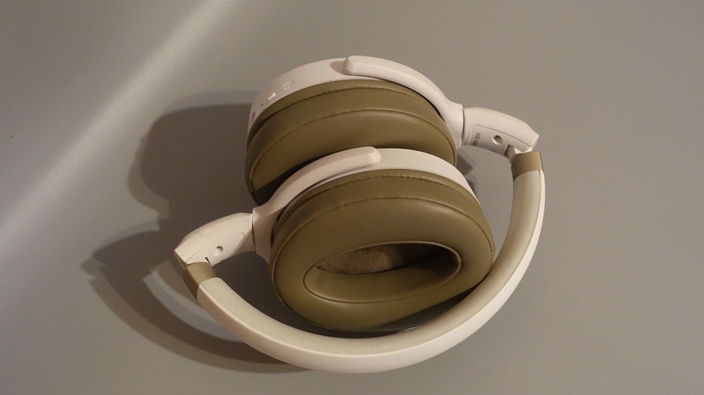 Picture of white Sennheiser HD 450BT headphones kept on a table with folded earcups