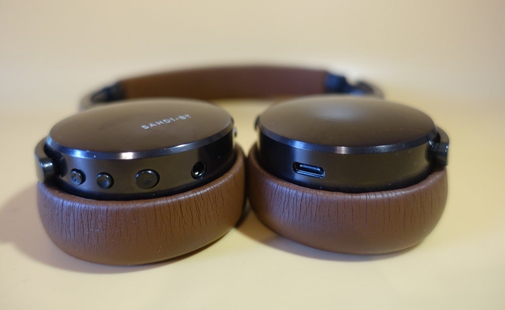 Status BT OneClose up image of brown-black Status BT One headphone's earcups