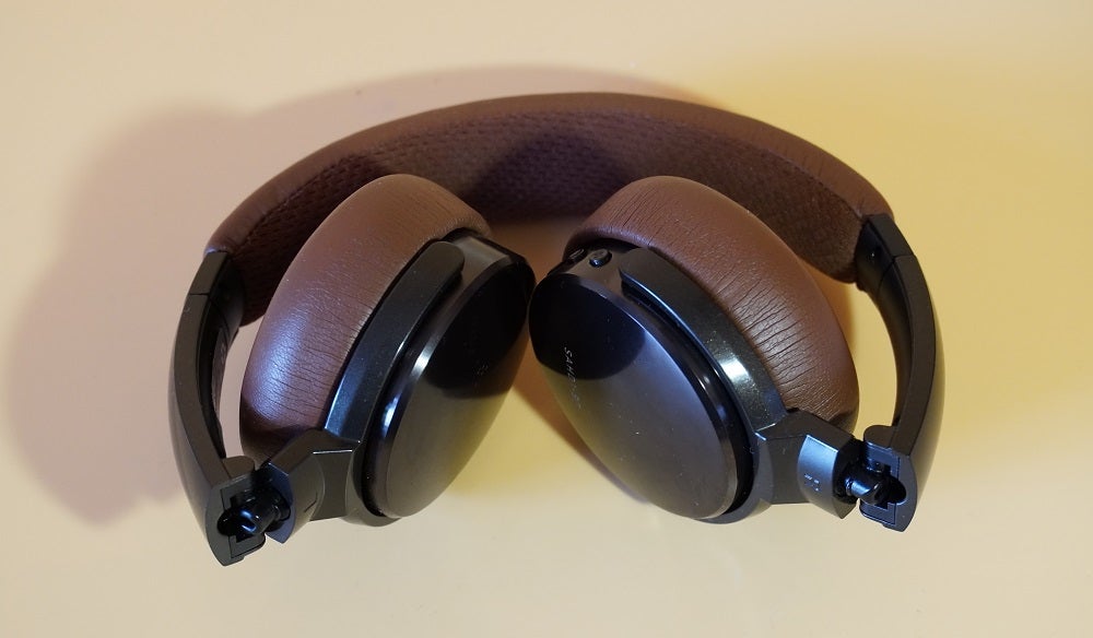 Status BT OneBrown-black Status BT One headphones kept on a table with earcups folded