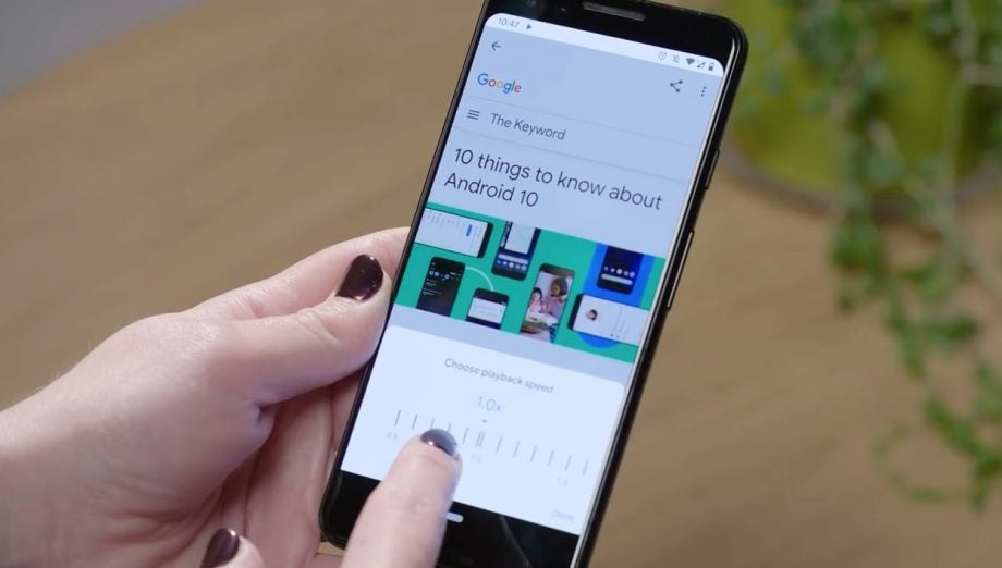 A black smartphone held in hand showing Google Assistant read aloud feature