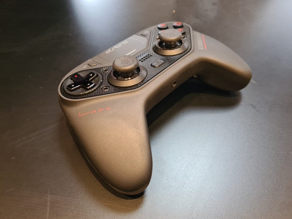 A black Astro C40 gaming controller kept on a black table