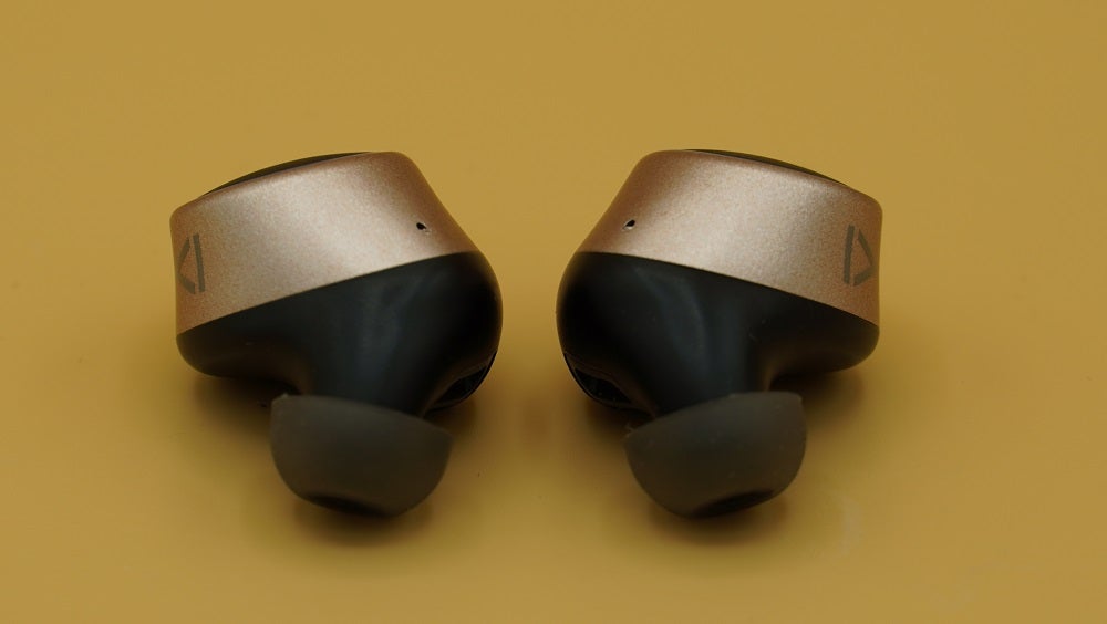 Creative Outlier GoldCreative Outlier Gold earbuds kept on a table