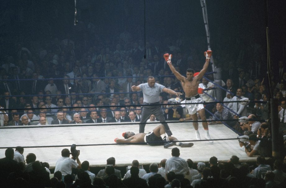 Picture of a scene from a boxing match with Muhammad Ali wining the match
