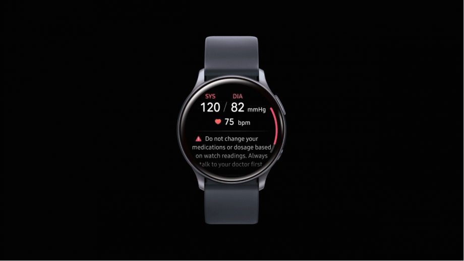 A gray Samsung Galaxy watch standing on black background displaying blood pressure
