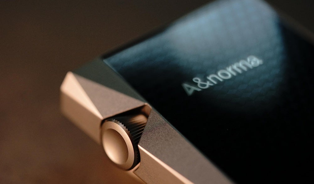 Close up image of a silver-black AK SR25 music player's scroll button