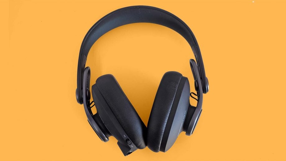 View from top of black AKG headphones kept on a yellow background
