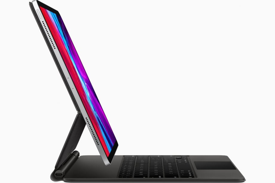 side view of a black iPad Pro with it's keyboard attached standing on a white background