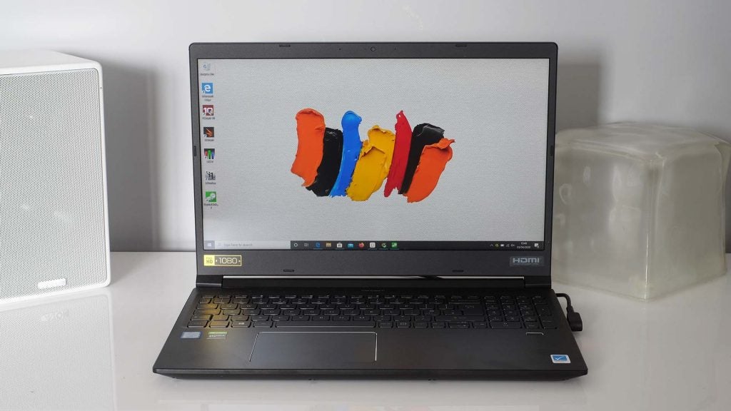 A black ConceptD laptop kept on a white table