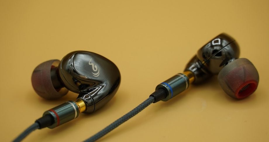 Close up image of black oBravo Cupid earphone's earbuds kept on a table