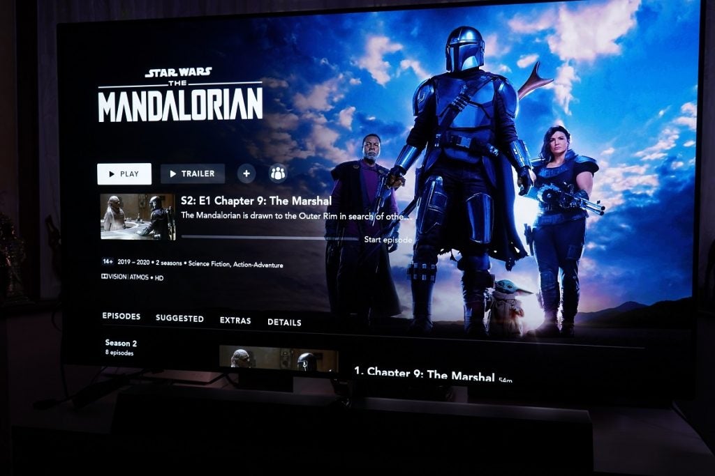Philips OLED displaying Star Wars: The Mandalorian menu with play and trailer button with episodes list below