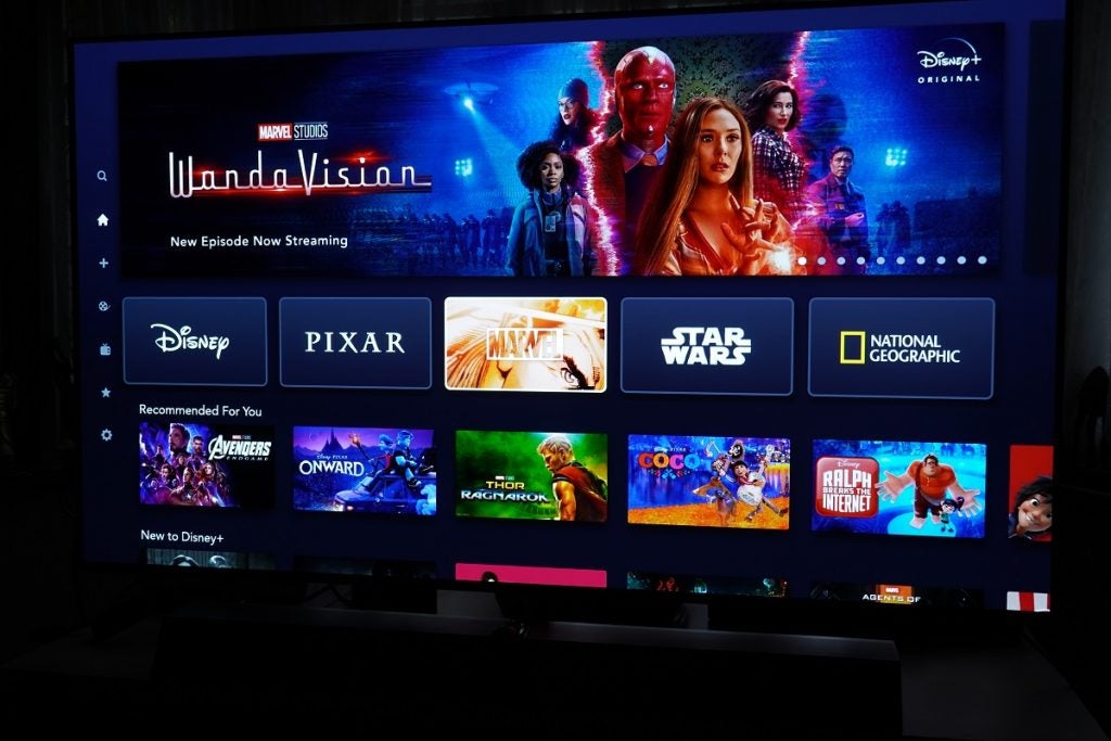 A TV displaying Disney Plus's home screen with recommended for you and new to Disney plus content