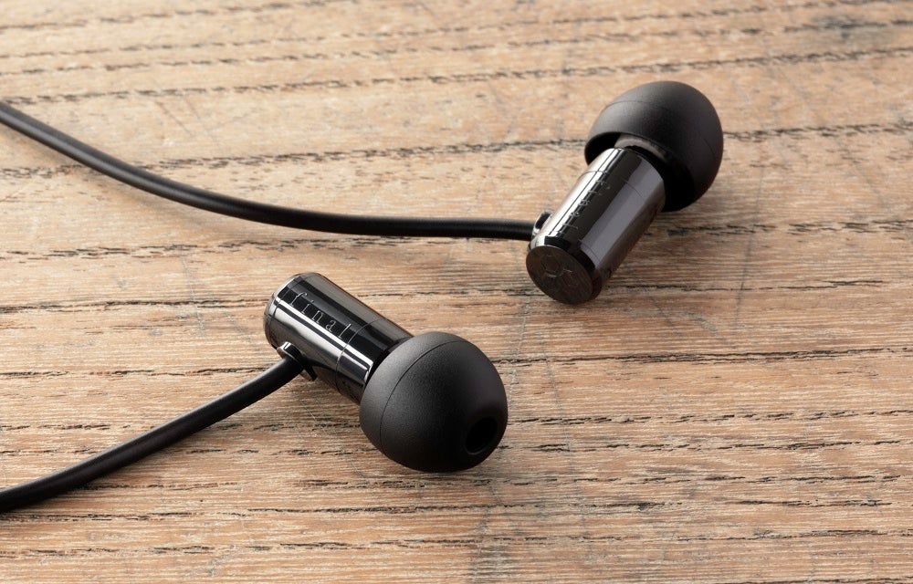 Black Final 500 wireless earphones kept on a wooden table