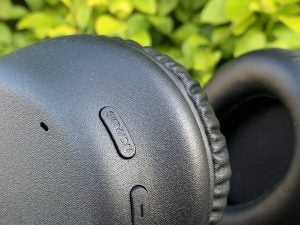 Close up image of black Sony WH CH710N headphones buttons on earcups