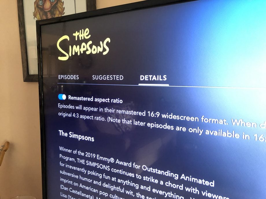 A black TV displaying The Simpsons on Disney+