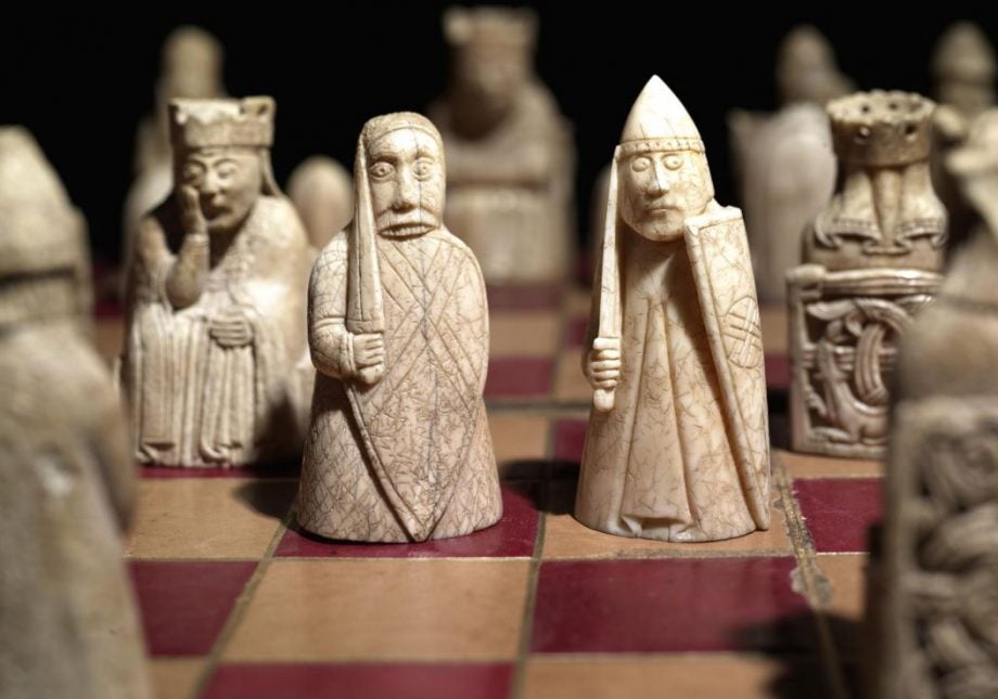 Lewis Chessman standing on a chessboard, picture from British Museum