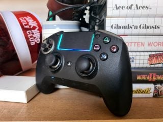 A black Razer Raiju Ultimate gaming controller standing against a tower of books