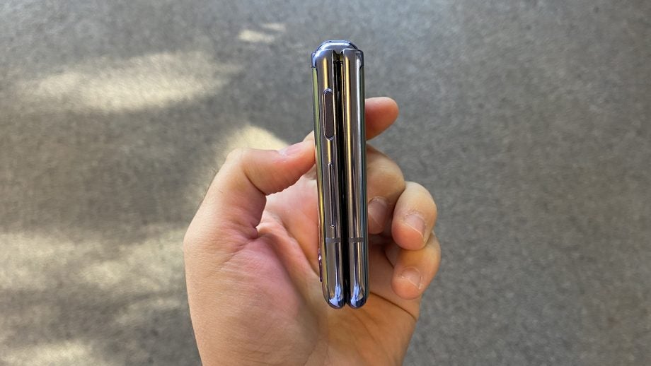 Side view of a Samsung Z flip held in hand in folded state