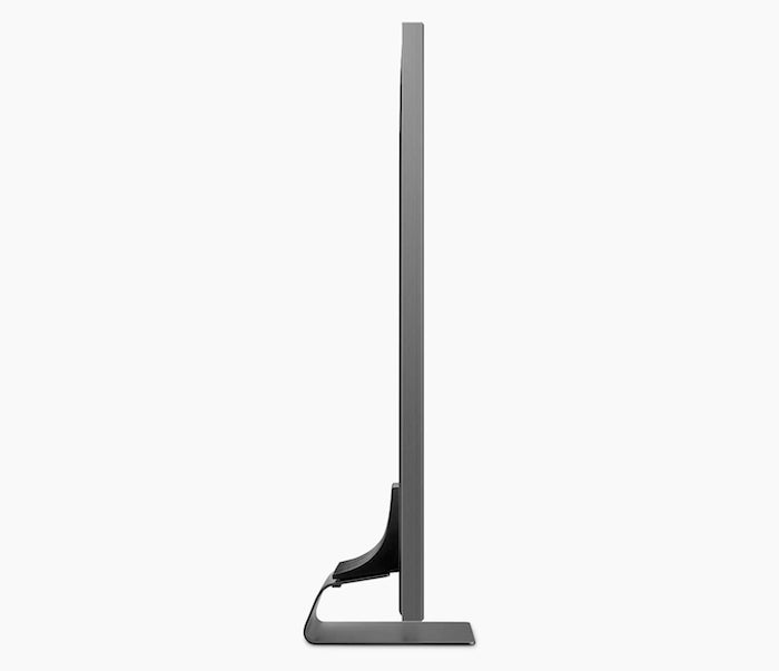 Side edge view of a black Samsung QE65Q95T direct LED TV standing on white background