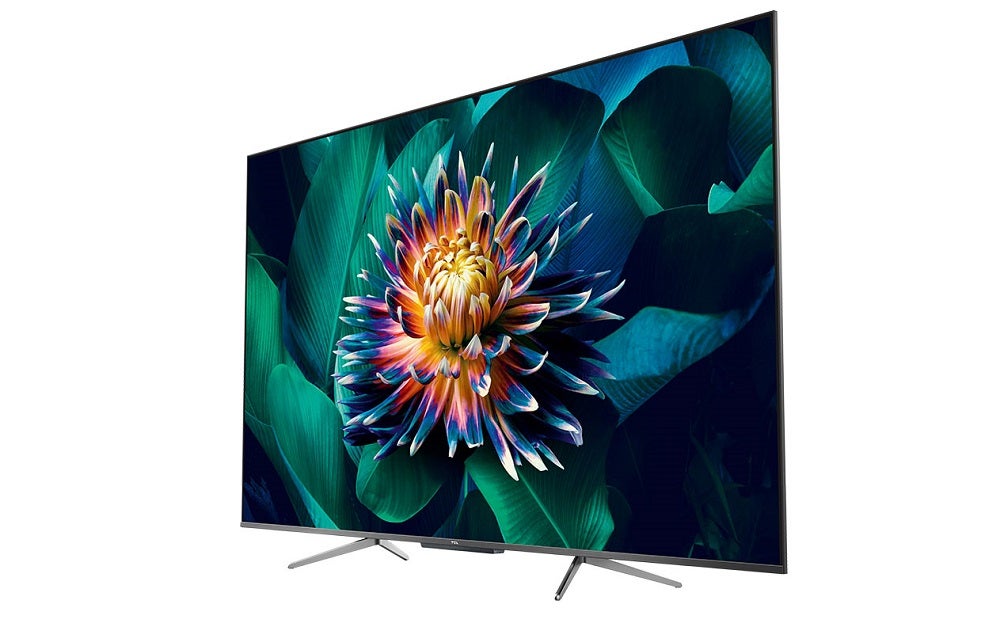 A silver TCL P10 TV standing on white background displaying a wallpaper of a flower