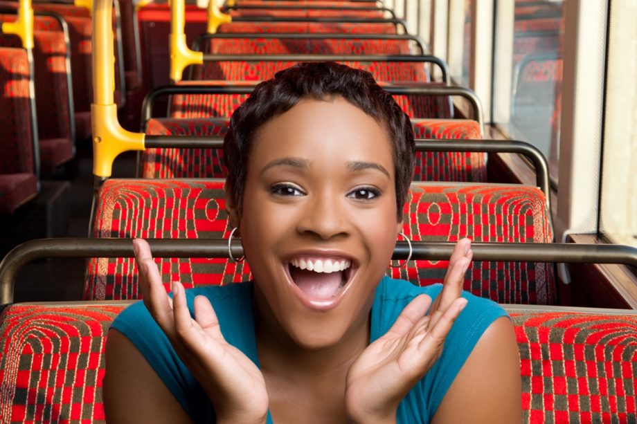 Picture of a woman in blue outfit sitting in a bus
