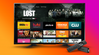 A black TV displaying Fire TV free tab's homescreen with a black Fire TV stick and remote kept on bottom right