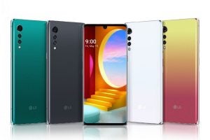 Five different colored LG Velvet smartphones standing on white background showing front and back panel 