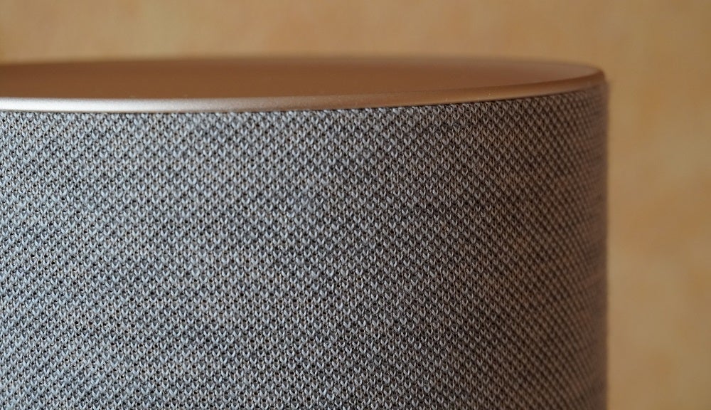 Close up image of a silver Beosound balance speaker's top portion